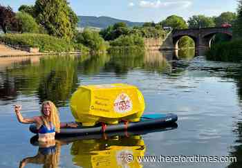 Campaigner swims down river Wye in Hereford with huge egg box