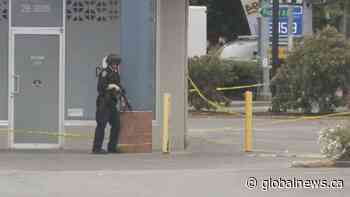 Two Saanich police officers remain hospitalized after bank shooting - Global News