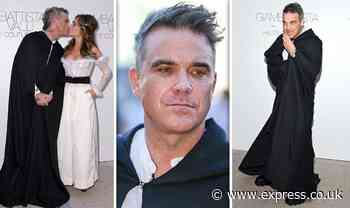 Robbie Williams dons dramatic cloak as he kisses stunning wife Ayda Field on red carpet - Express