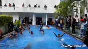 Protesters take a swim in presidential pool after storming palace