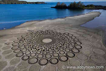 Tides overtake sprawling sand sculpture mural on B.C. beach, just as artist planned