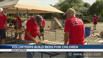 Local volunteers build beds for children in need