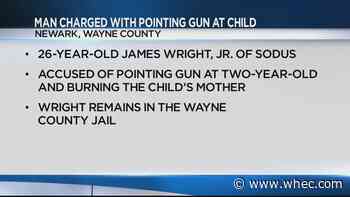 Man holds gun to woman's child