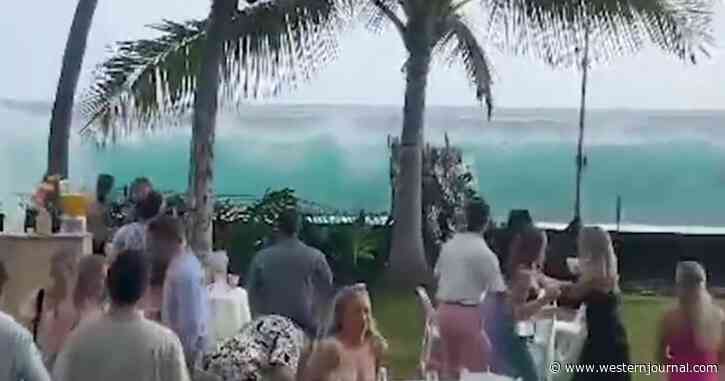 Oceanside Wedding Guests Can Only Stare at Massive Oncoming Wave, Watch the Moment They Realize Seawall Isn't Going to Stop It