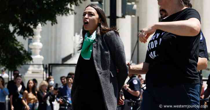 Watch: AOC Appears to Fake Having Handcuffs On While Being Removed by Police