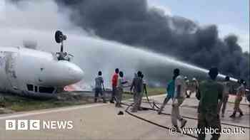 Somalia plane crash: Firefighters tackle blaze by flipped-over plane