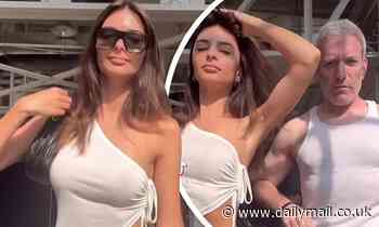 Emily Ratajkowski shows off her abs as she dances around with her pal after split from husband