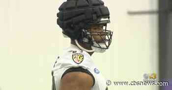 A new sight at Baltimore Ravens training camp: Guardian Caps - CBS News