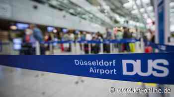 Mitten auf dem Rollfeld: Arbeiter am Düsseldorfer Flughafen posieren mit IS-Gruß