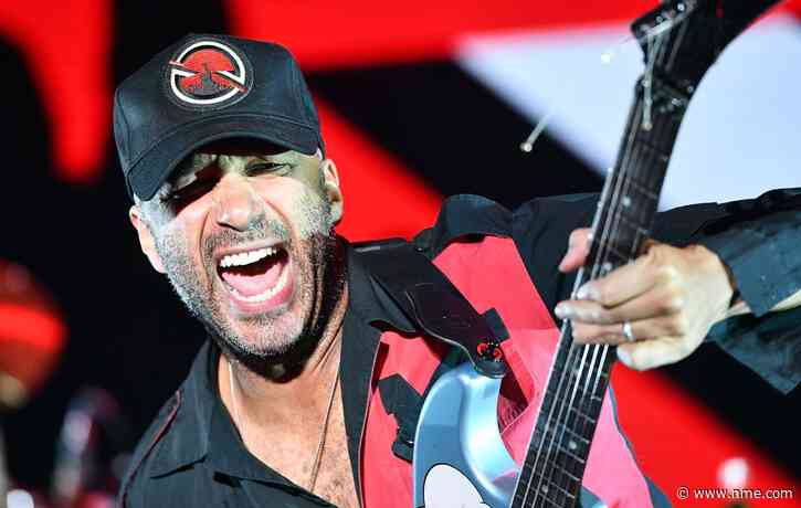 Tom Morello tackled by security after fan crashes stage at Rage Against The Machine show