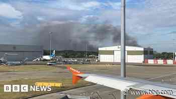 Fire crews tackle field fire close to London Luton Airport - BBC