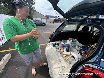 Classic art reimagined around sweet themes on fence at Oliver's Candies - The Batavian