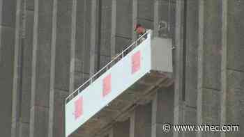 2 window washers are happy to be back on solid ground