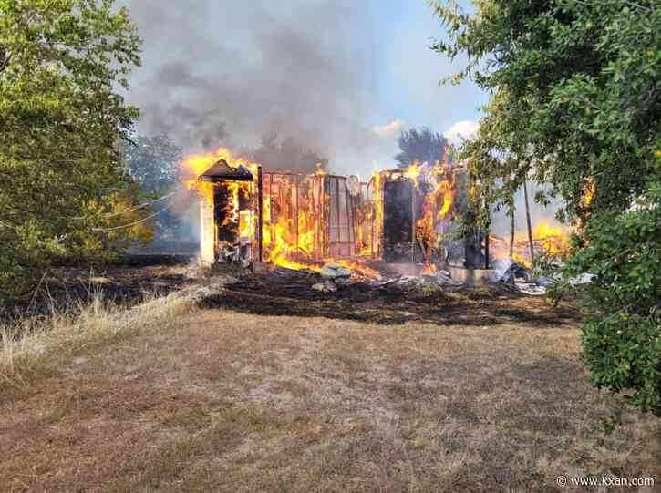 Structure fire in Manor, brush and grass involved