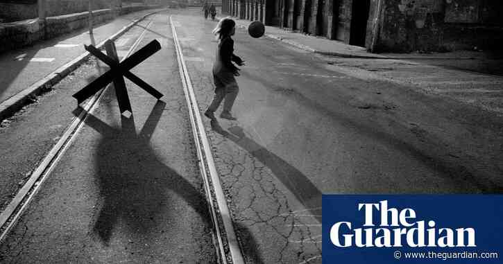 A kid playing with a ball next to a tank trap: Paul Lowe’s best photograph
