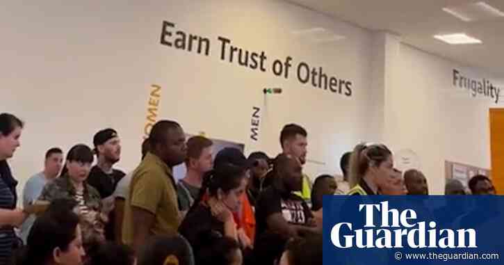 Hundreds of Amazon employees stop working over disputed pay rise – video