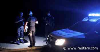 Ukraine police patrol dark night time streets, seeking curfew violators - Reuters