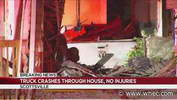 Truck crashes through Scottsville home, man in custody