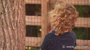 A toddler was playing with bubbles in the backyard. Then he spotted something unusual