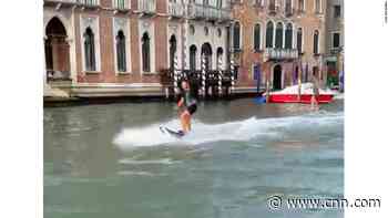 Tourists fined for surfing up Venice's Grand Canal