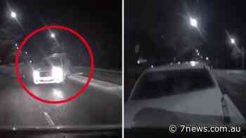 Shocking moment driver rams police car head on caught on dash-cam - 7NEWS