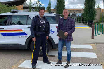 Red Deer RCMP return stolen plaque - Red Deer Advocate