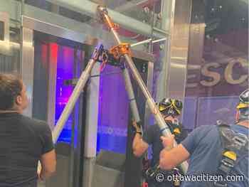 Firefighters rappel down elevator shaft, rescue trapped passenger at transit station