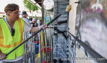 Volunteers remove trash and paint over graffiti in Chinatown