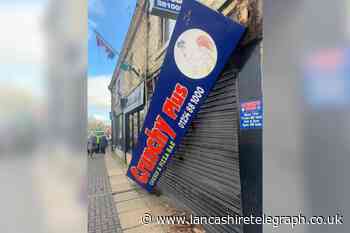 Great Harwood residents work to take down partially fallen sign