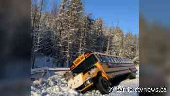 School bus tips into deep ditch