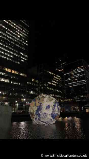 East London's Canary Wharf Winter Light Show. Floating Globe