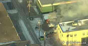 Commercial building in Edmonton evacuated after neighbouring structure catches fire