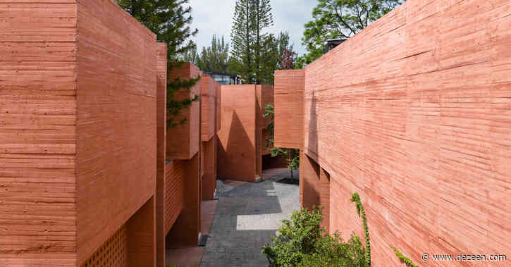 Geometric perforations characterise coloured concrete housing block in Mexico