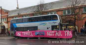 Extinction Rebellion activists surround Bristol Airport bus in transport protest