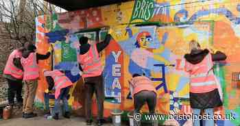 Volunteers help to restore graffiti-damaged murals