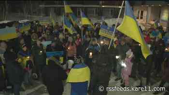 Hundreds march across Lowry Ave. bridge in solidarity with Ukraine one year later