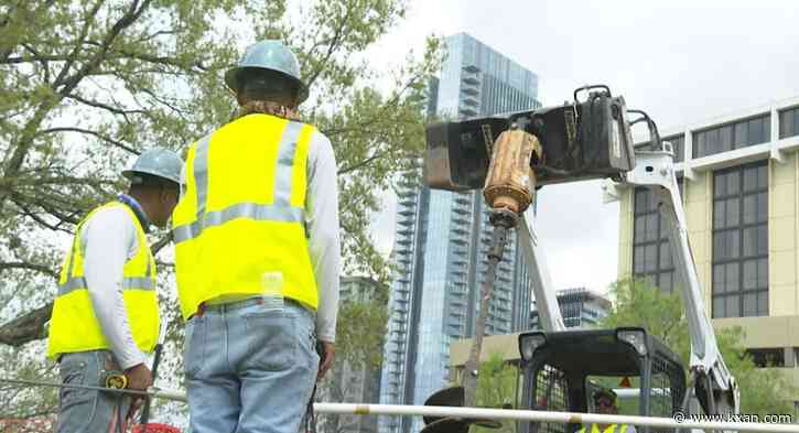 Crews put up trail fence, lighting near Rainey Street