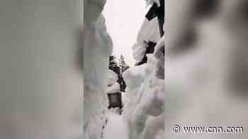 Man builds 12-foot-tall snow tunnel to get out of home