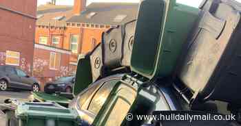 Police called after car buried under mountain of wheelie bins