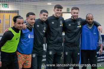 Burnley FC players enjoy football game at charity's  refugee scheme