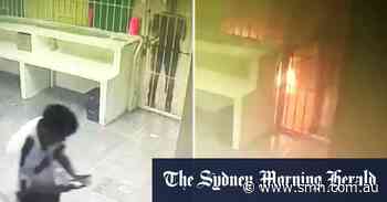 Video shows detainees locked behind gates as fire breaks out in detention centre