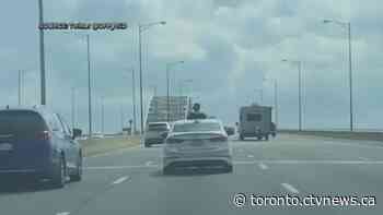 Woman charged after allegedly sticking head out of sunroof on Toronto-area highway