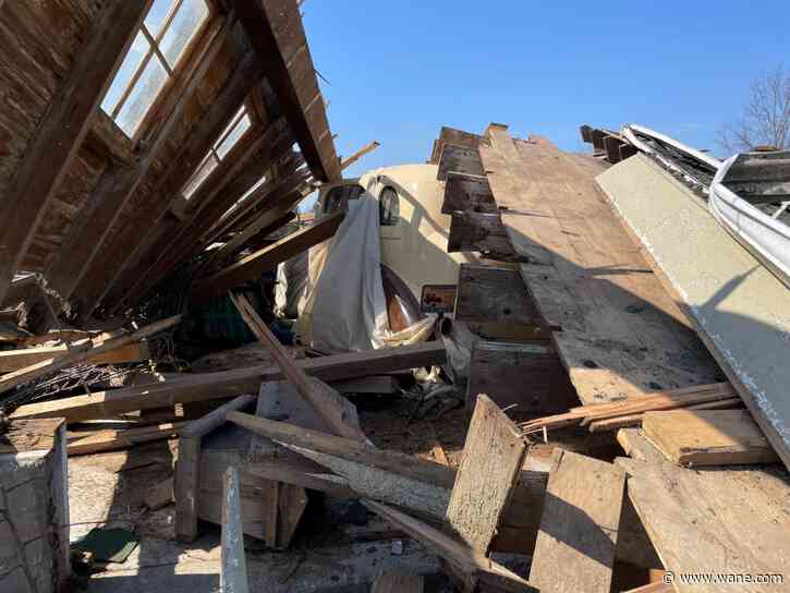 What are your options to escape a tornado while in a car?