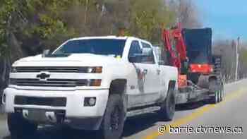Image of suspect truck hauling stolen excavator  released as OPP seeks to ID the driver