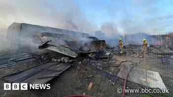 Commercial buildings collapse after fire