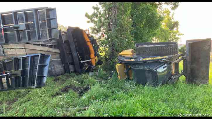 Truck carrying heavy equipment flips along I-10 West; traffic slowed to a crawl at LA 415