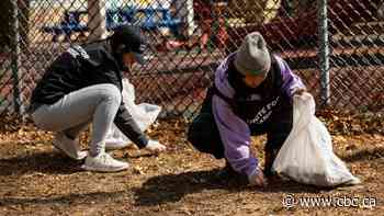 Volunteers clean up trash in Grange Park day before Earth Day