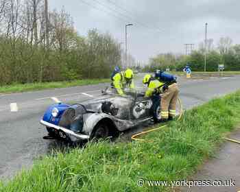 Classic sports car bursts into flames on way to rally