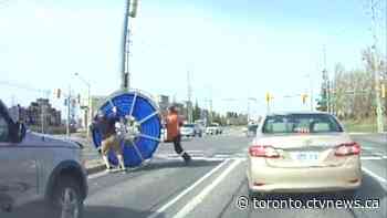 Video shows giant spool of cable rolling through busy Newmarket intersection