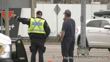 Driver charged in North Bay when rock crusher falls from truck onto pickup